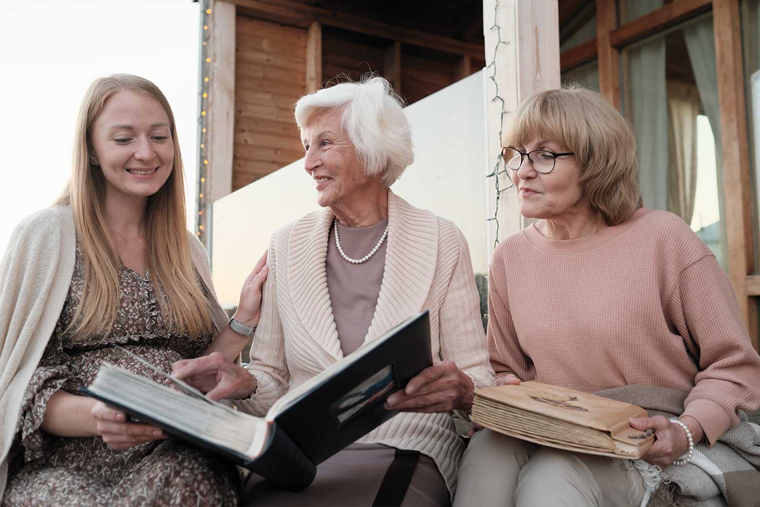 three generations of women looking at photo albums together indexed universal life fort worth tx